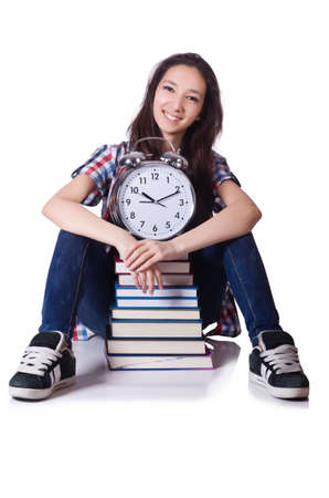 Young female student missing her deadlines on whiteの写真素材