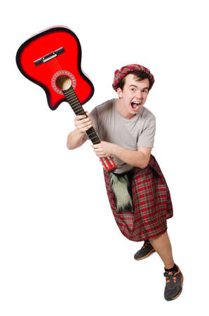 Scotsman playing guitar isolated on whiteの写真素材