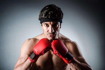 Muscular boxer wiith red gloves