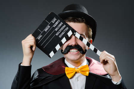Funny man with movie clapper boardの写真素材