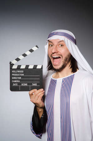 Arab businessman with movie boardの写真素材