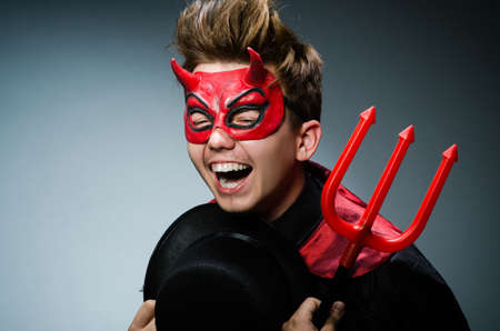 Funny devil against dark background