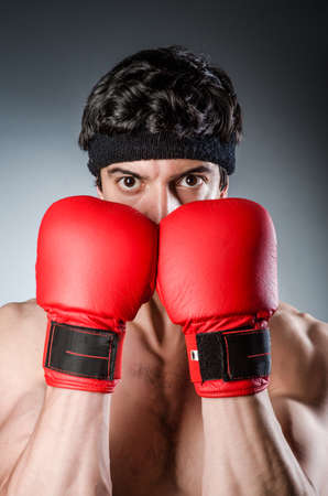 Muscular boxer wiith red gloves