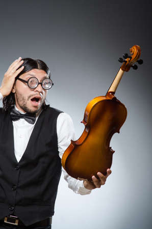 Funny fiddle violin player in musical conceptの写真素材