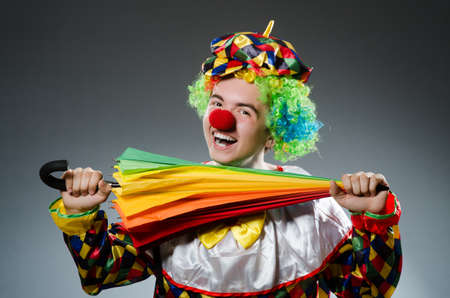 Funny clown with colourful umbrellaの写真素材