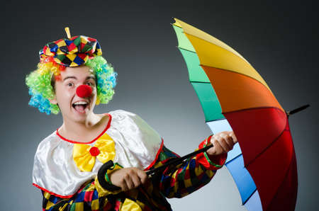 Funny clown with colourful umbrellaの写真素材