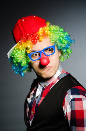 Funny clown against the dark backgroundの写真素材