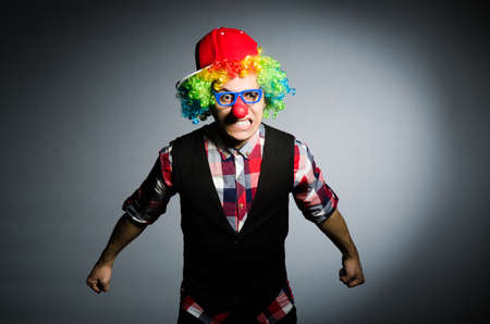 Funny clown against the dark backgroundの写真素材