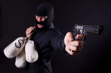 Man wearing balaclava with gun