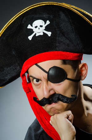 Funny pirate in the dark studioの写真素材