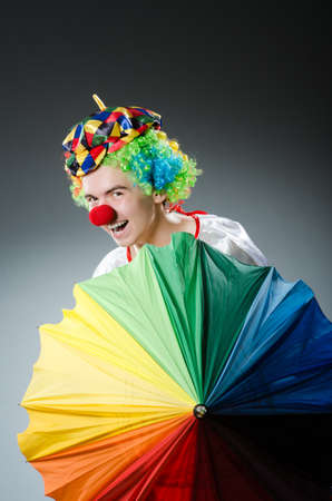 Funny clown with colourful umbrellaの写真素材