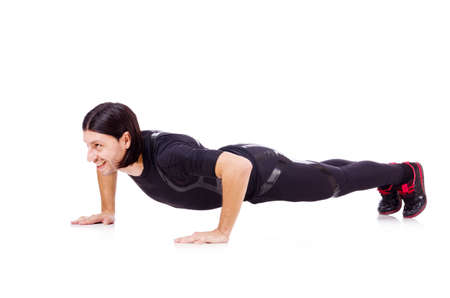 Young man doing exercises on white