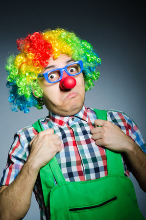 Funny clown against the dark backgroundの写真素材