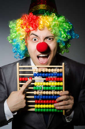 Funny clown businessman with abacusの写真素材