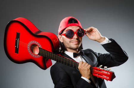 Funny guitar player in studioの写真素材