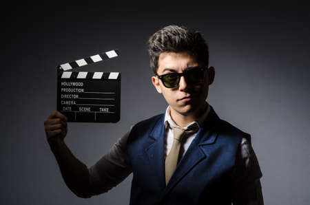 Funny man with movie clapboardの写真素材