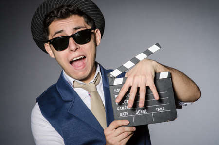 Funny man with movie clapperの写真素材