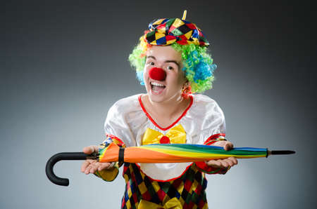Funny clown with colourful umbrellaの写真素材