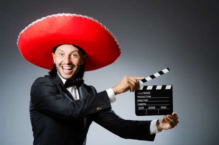 Mexican man with movie board clapboardの写真素材