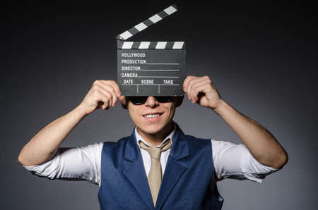 Funny man with movie clapboardの写真素材