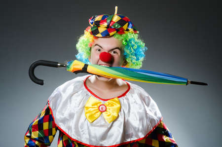Funny clown with colourful umbrella