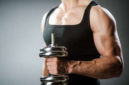 Muscular ripped bodybuilder with dumbbellsの写真素材