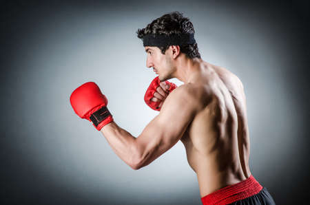 Muscular boxer wiith red gloves