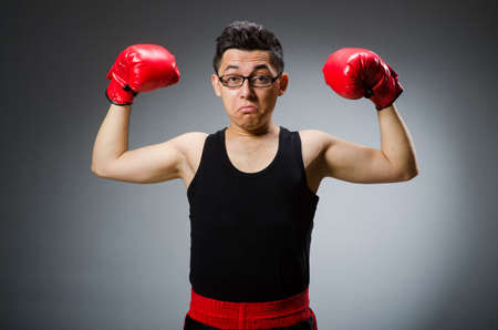 Funny boxer with red gloves against dark backgroundの写真素材