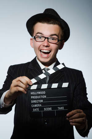 Man with movie clapperboard and hatの写真素材