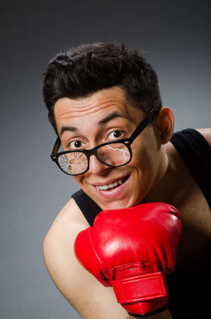 Funny boxer with red gloves against dark backgroundの写真素材