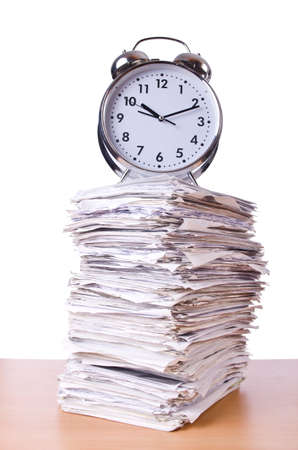 Stack of papers and clock isolated on whiteの写真素材