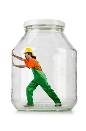 Man in coveralls imprisoned in glass jarの写真素材