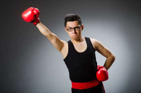 Funny boxer with red gloves against dark backgroundの写真素材