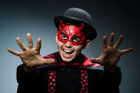 Funny devil against dark backgroundの写真素材