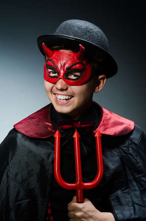 Funny devil against dark backgroundの写真素材
