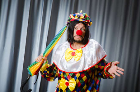Funny clown with colourful umbrellaの写真素材