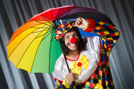 Funny clown with colourful umbrellaの写真素材