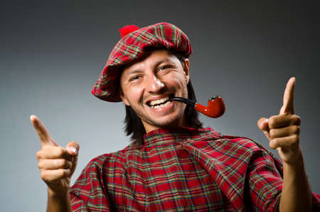 Funny scotsman with smoking pipeの写真素材
