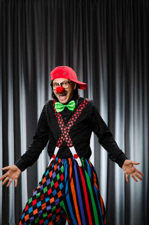  Funny clown in humorous concept against curtainの写真素材