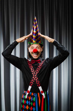  Funny clown in humorous concept against curtainの写真素材