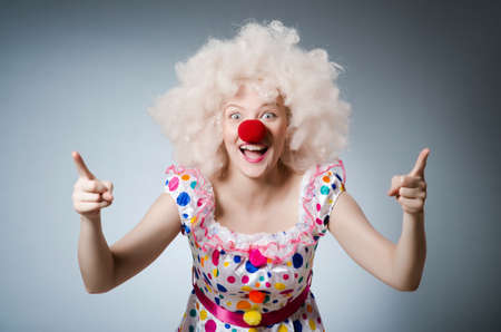 Clown with white wig against grey backgroundの写真素材