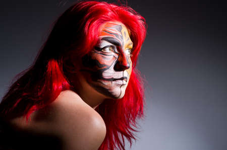 Woman with tiger face in halloween concept
