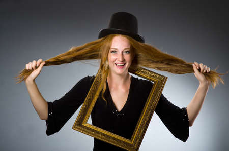 Woman with vintage hat and picture frame