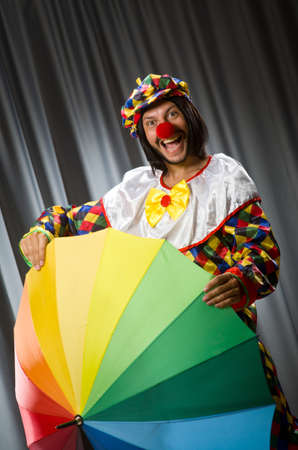 Funny clown with colourful umbrellaの写真素材