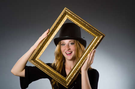 Woman with vintage hat and picture frameの写真素材