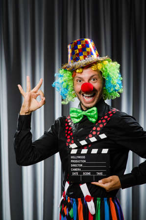 Clown with movie clapper board