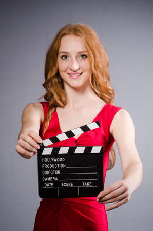 Woman in red dress with movie boardの写真素材
