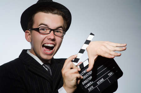 Man with movie clapperboard and hatの写真素材