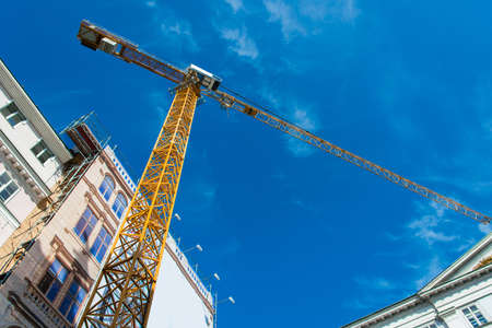 Construction crane next to the buildingの写真素材
