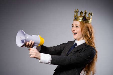 Queen businessman with loudspeaker in funny conceptの写真素材